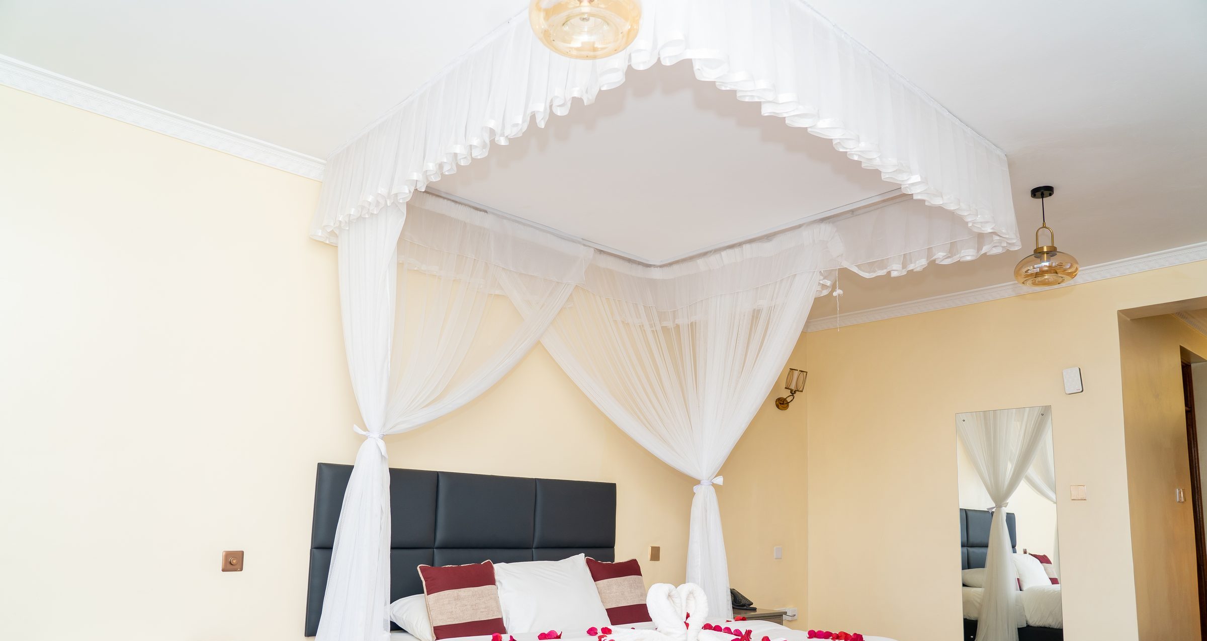 Net, headboard, and petals on the bed