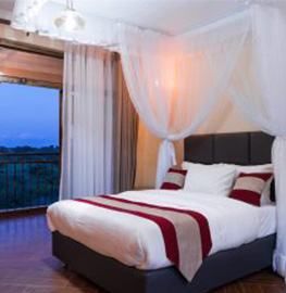 A single bed opening onto a balcony
